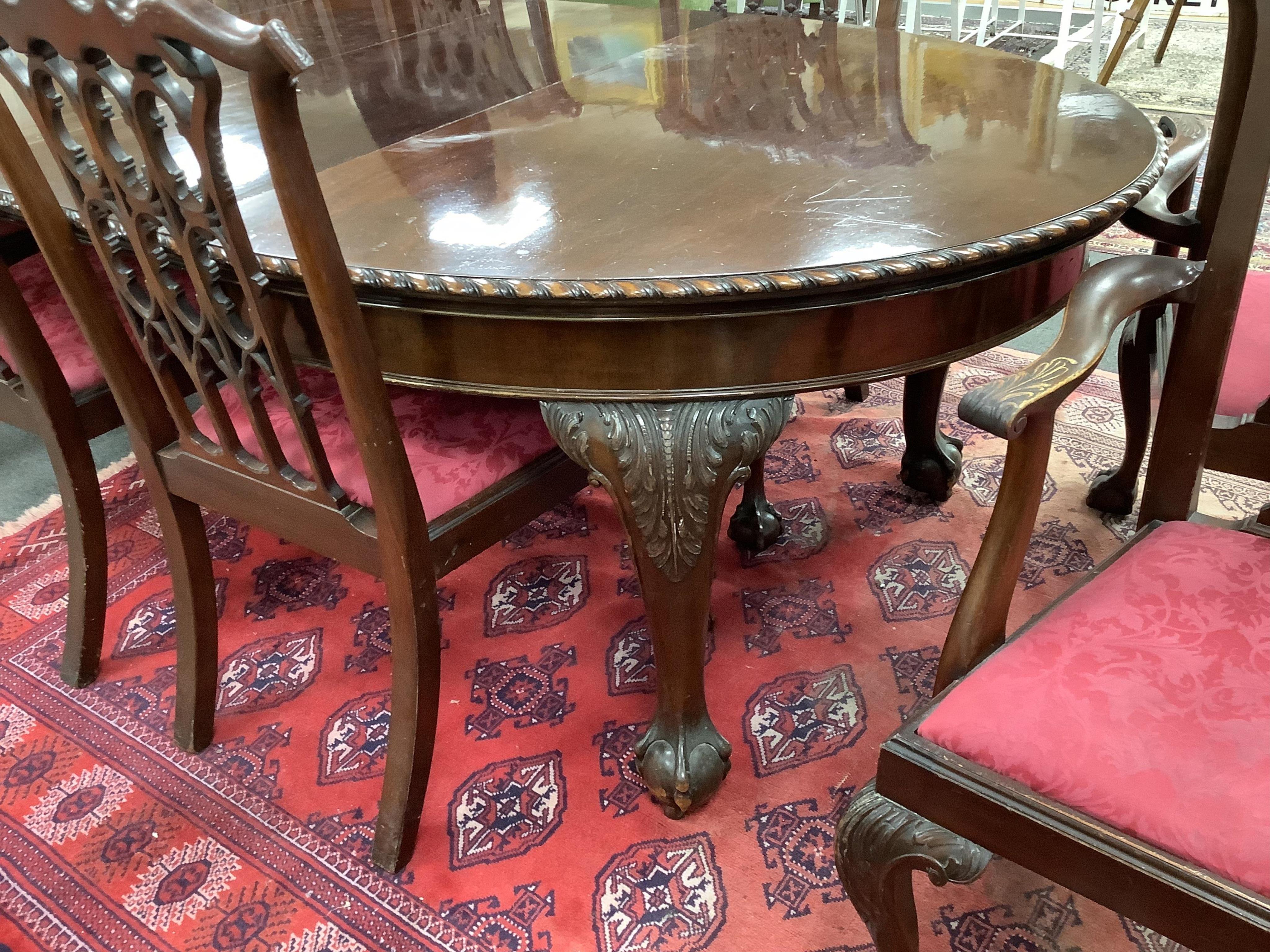 A Chippendale Revival mahogany dining suite comprising an extending dining table, width 300cm extended, depth 122cm, height 74cm, ten chairs (two with arms), a serpentine sideboard and a serving table. Condition - fair t